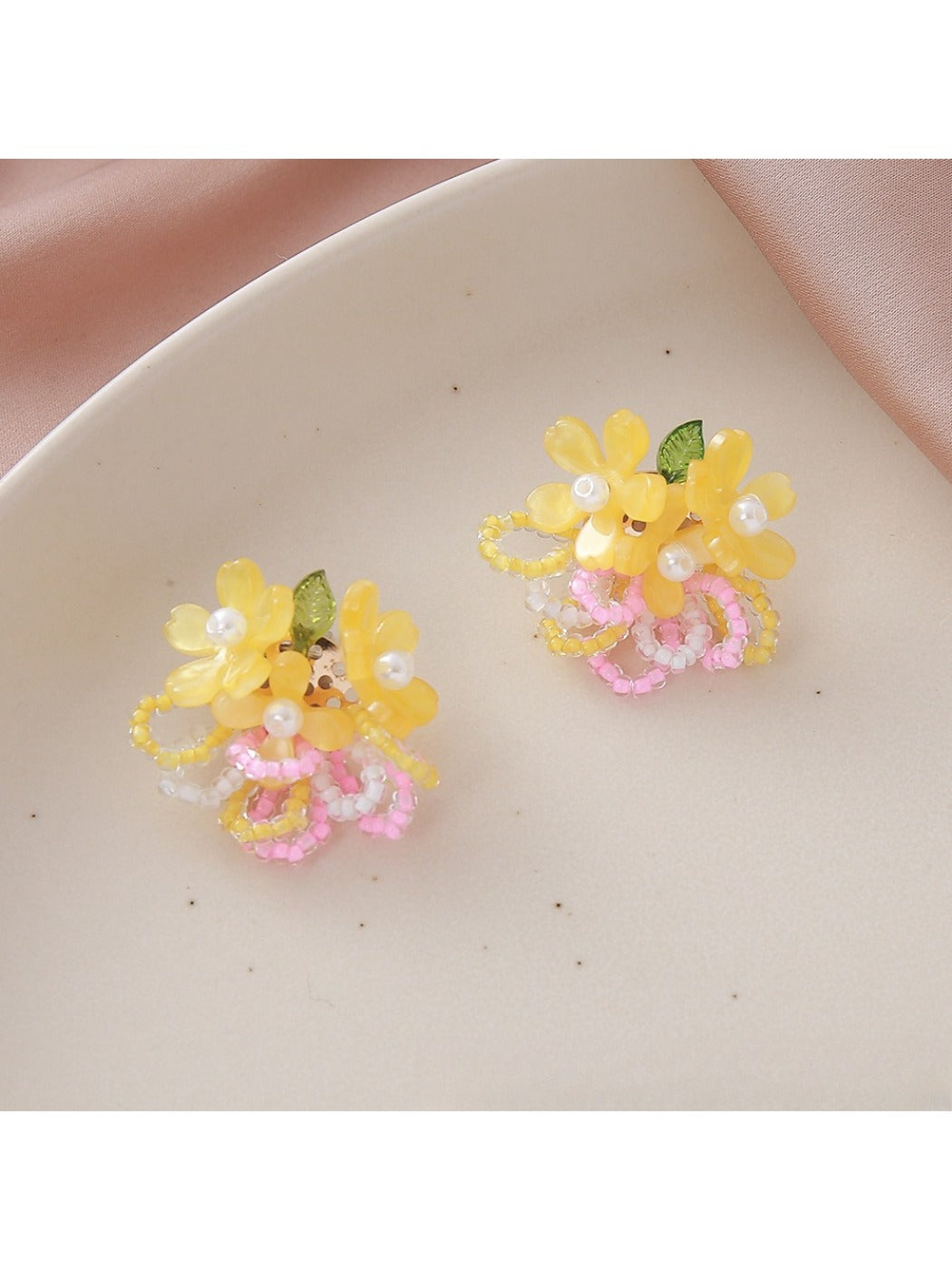 Earedge small flower cluster earrings with multicolor beads shown against dark background