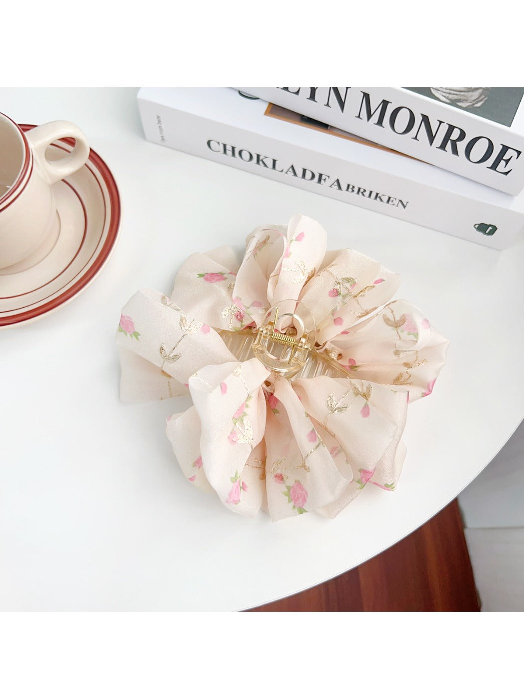 Beau Sweet Floral Print Hair Claw Clip resting on wooden surface