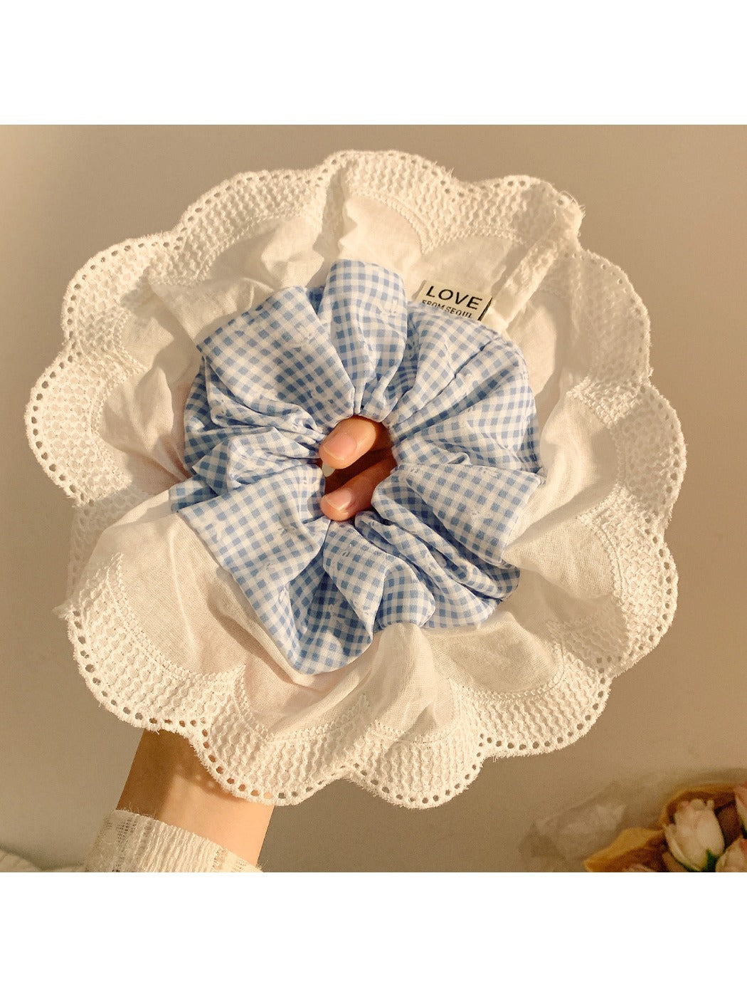 Flat lay of large plaid ruffle scrunchie on white background