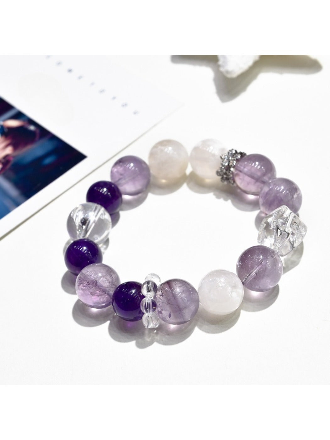 Lovra purple crystal beaded bracelet with silver accents on a white background