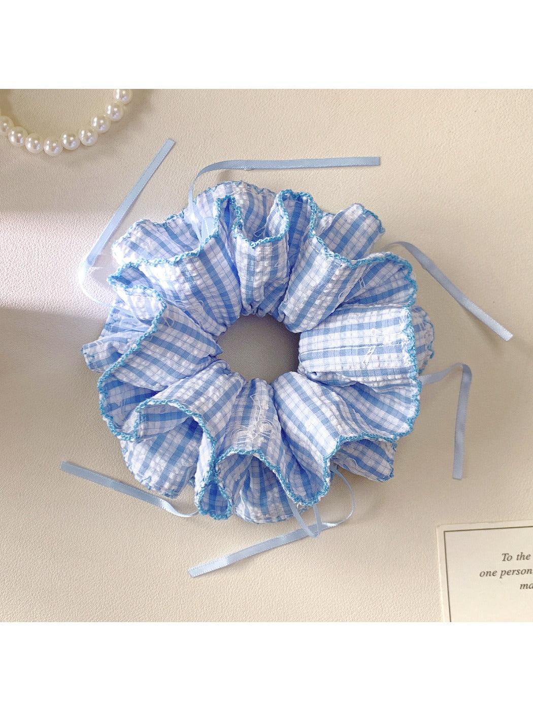 Side view of blue plaid double layer hair scrunchie showing fabric texture