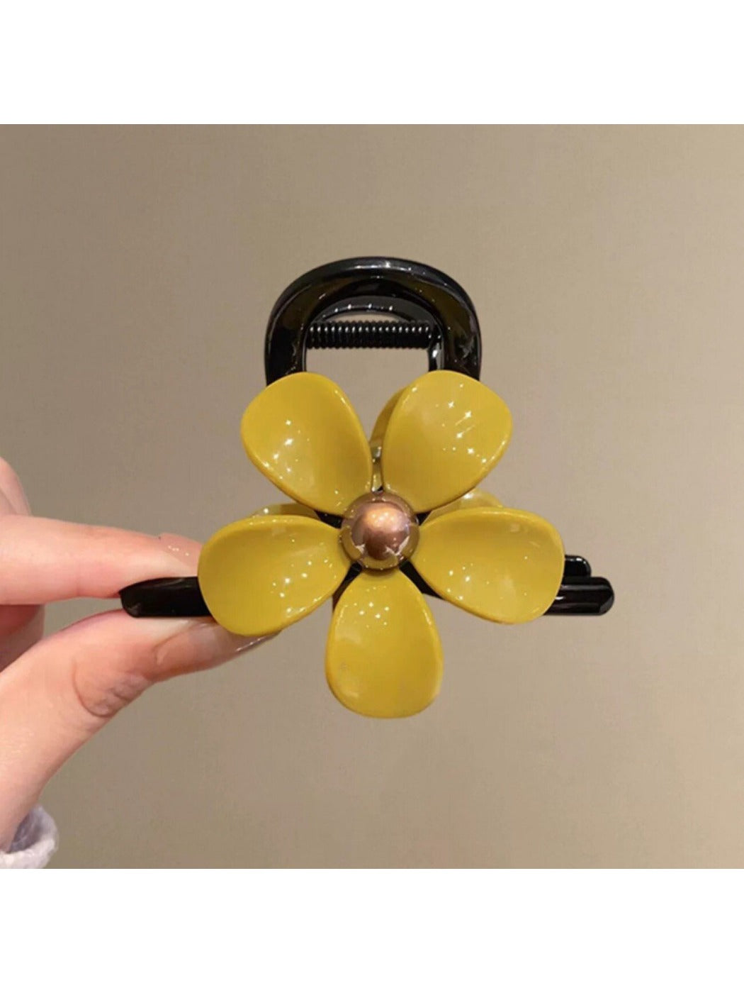 Beau flower-shaped claw clip positioned upright showing full design