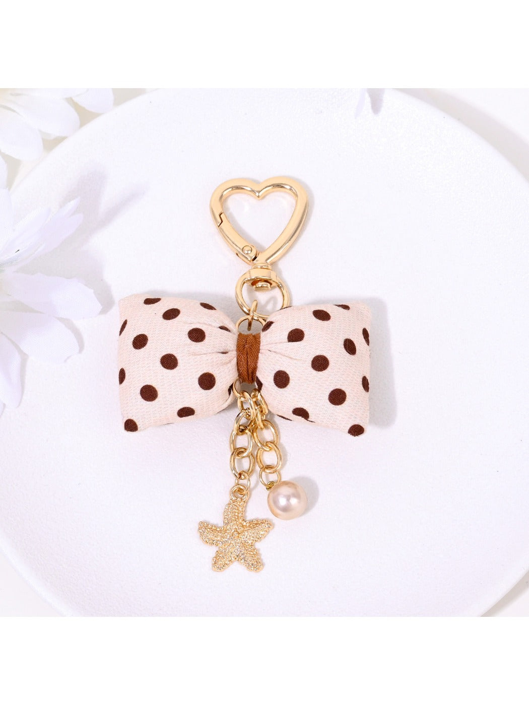 Keypus bow keychain displayed on a white background with metal keyring visible