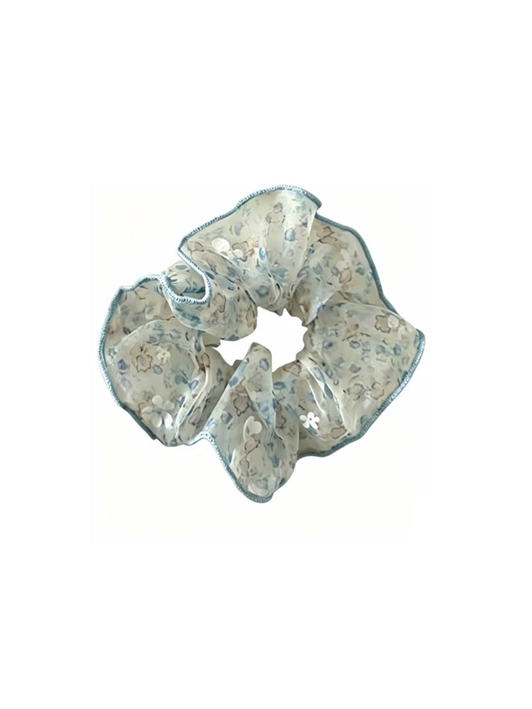 Gifty sheer tulle scrunchie styled in hair, emphasizing its delicate tiny floral pattern and sheer material