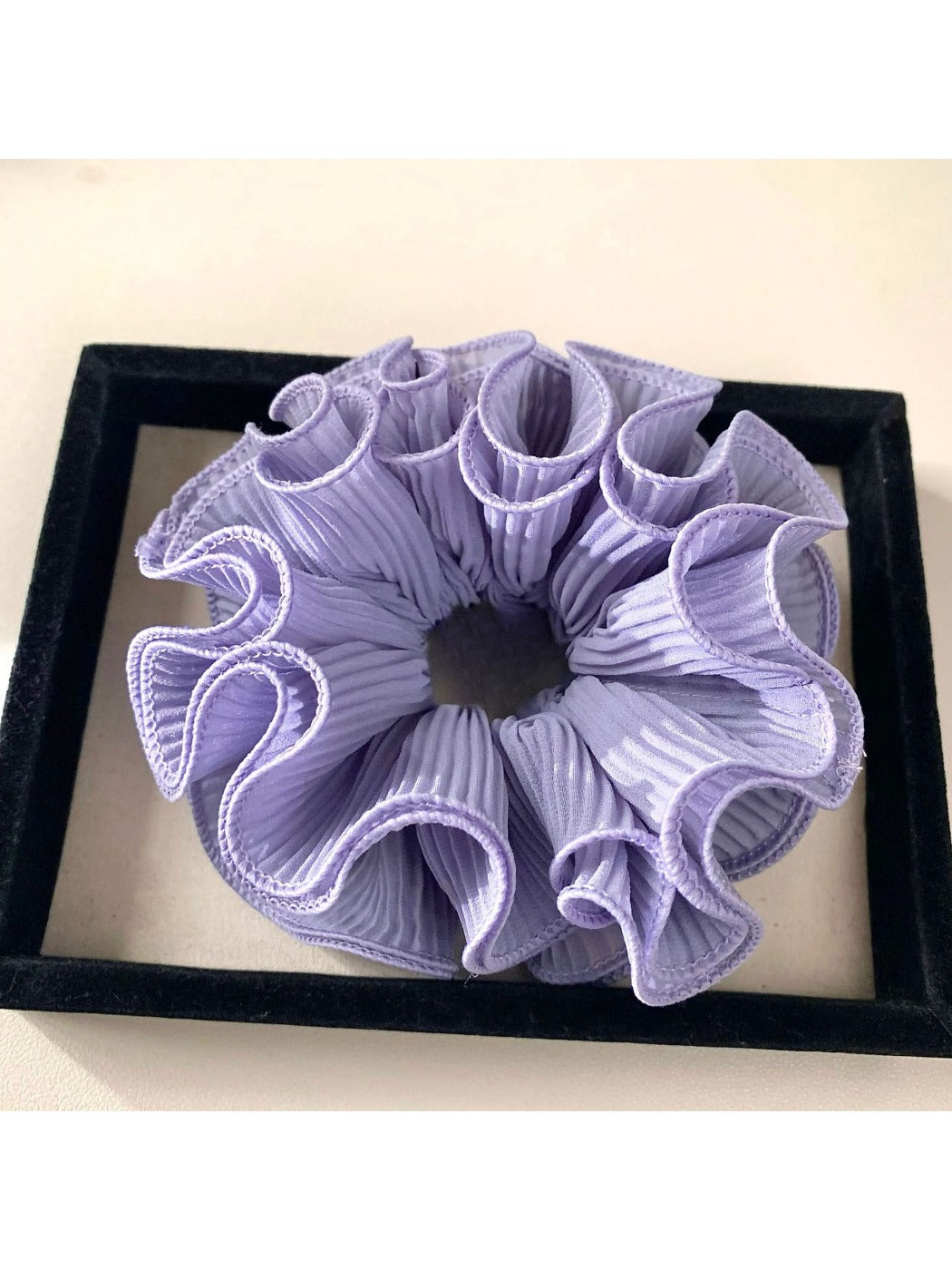 Gifty minimalist solid color ruffle scrunchie folded neatly on a flat surface
