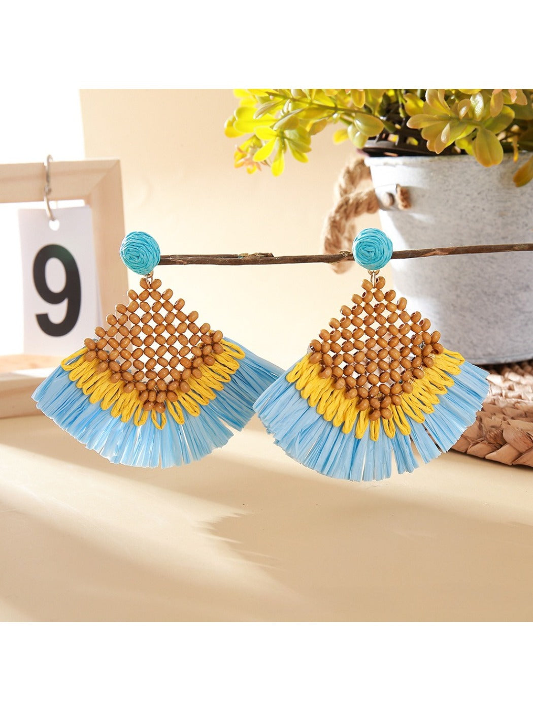 Vintage square raffia drop earrings displayed in a jewelry box with soft fabric lining