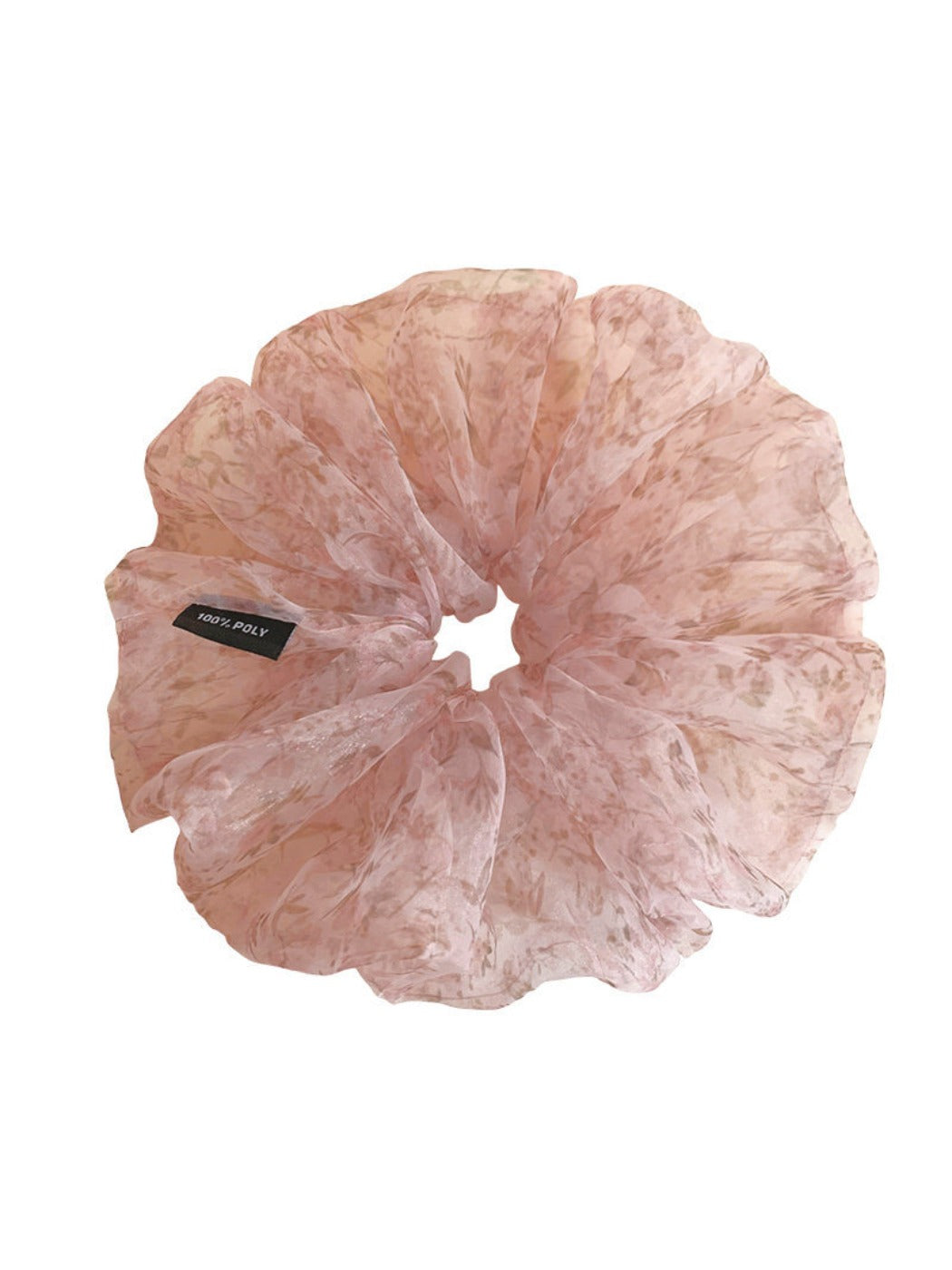 Pink floral tulle scrunchie displayed on a flat surface with soft lighting