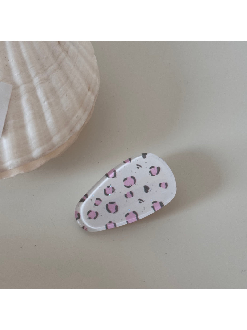 Beau hair clip positioned next to vintage jewelry pieces, enhancing its sophisticated look