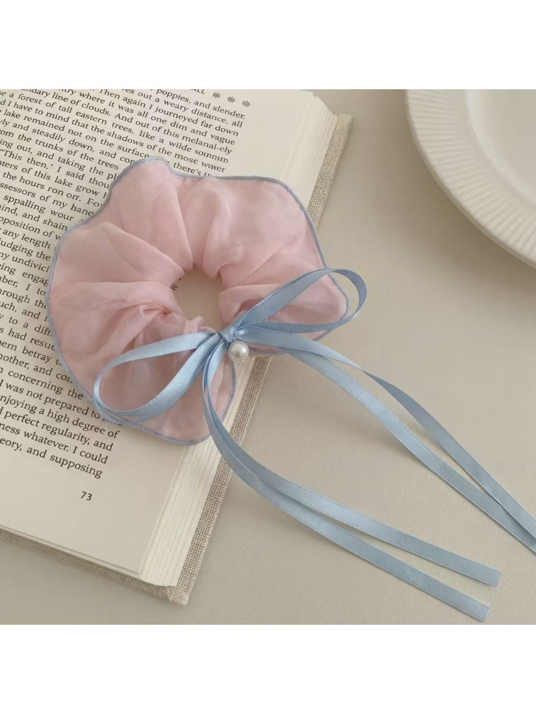 Gifty scrunchie worn on a wrist, highlighting its size and ruffled design