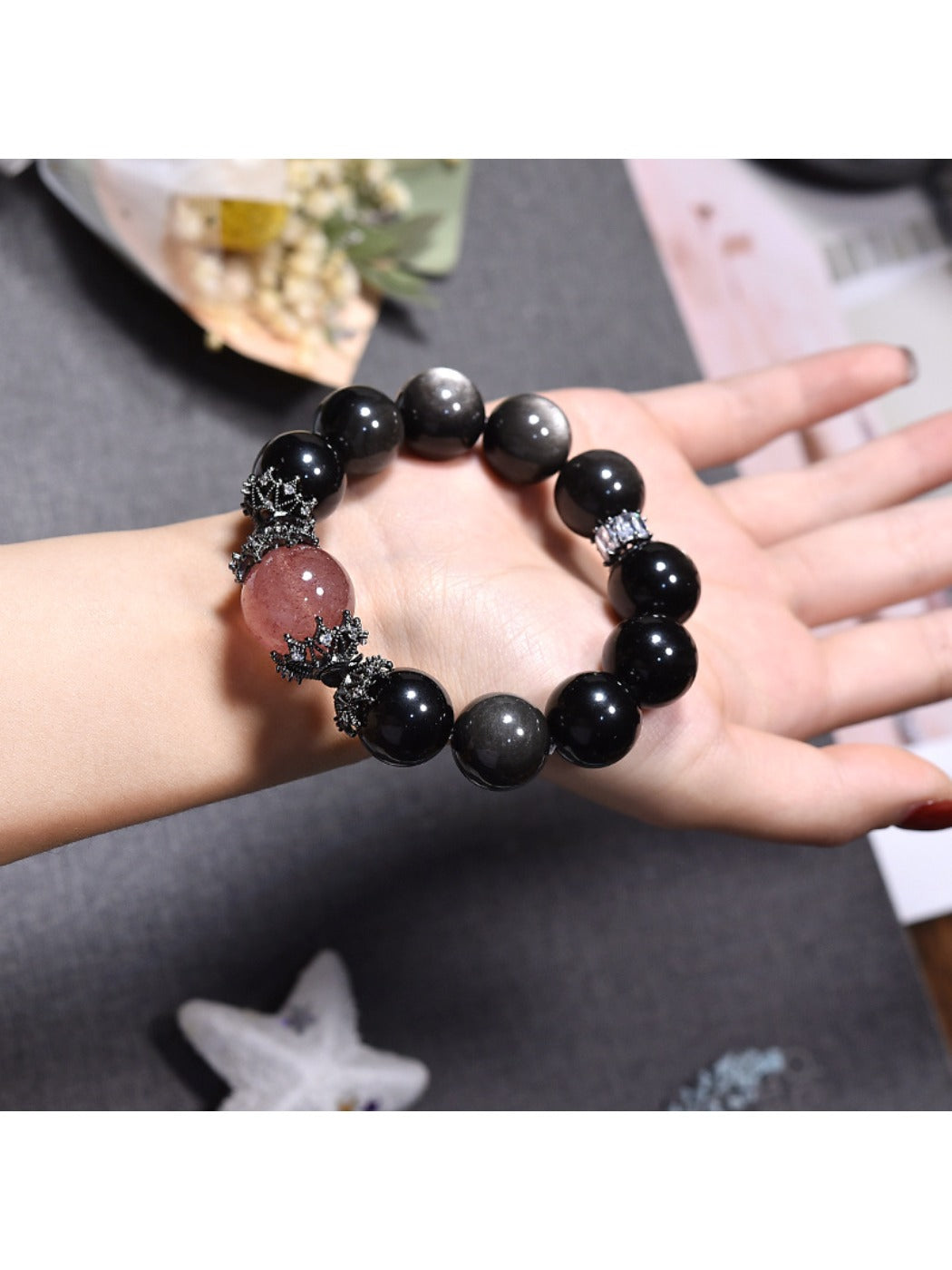 Lovra black crystal beaded bracelet worn on a wrist with a neutral background