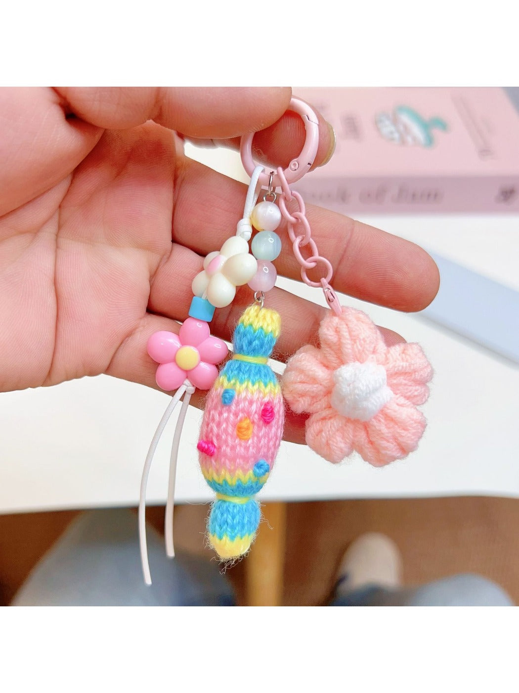 Crochet candy keychain attached to a set of keys on a wooden surface