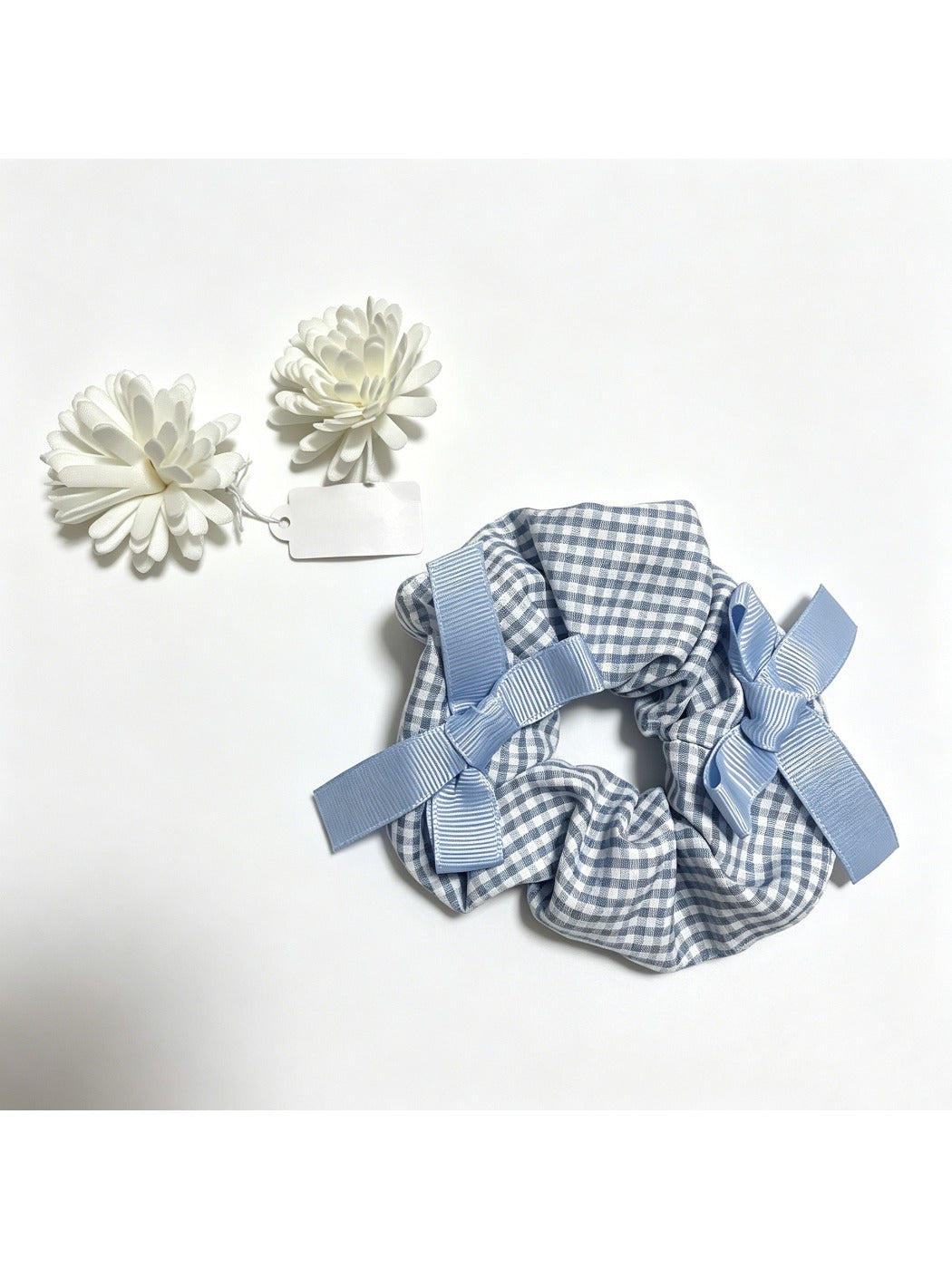 Gifty Sweet Bow Embellished Plaid Scrunchie displayed flat highlighting bow embellishment and plaid fabric