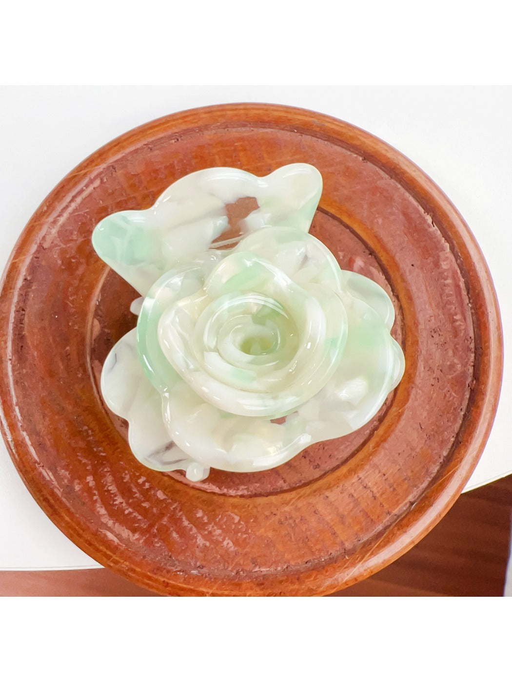 Beau flower-shaped claw clip in matte finish with visible spring clasp detail
