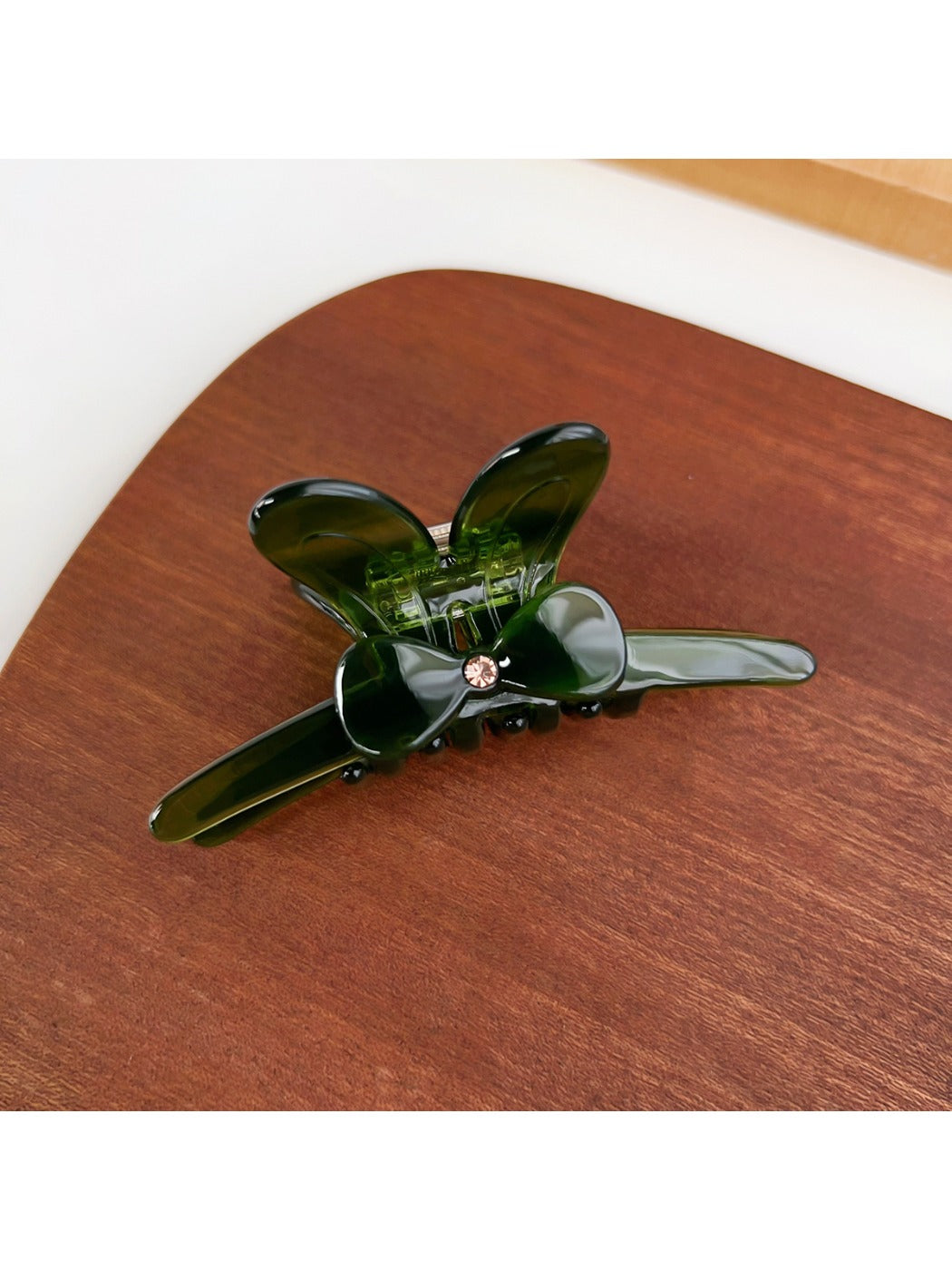 Beau bow adorned hair claw clip shown from angled side view