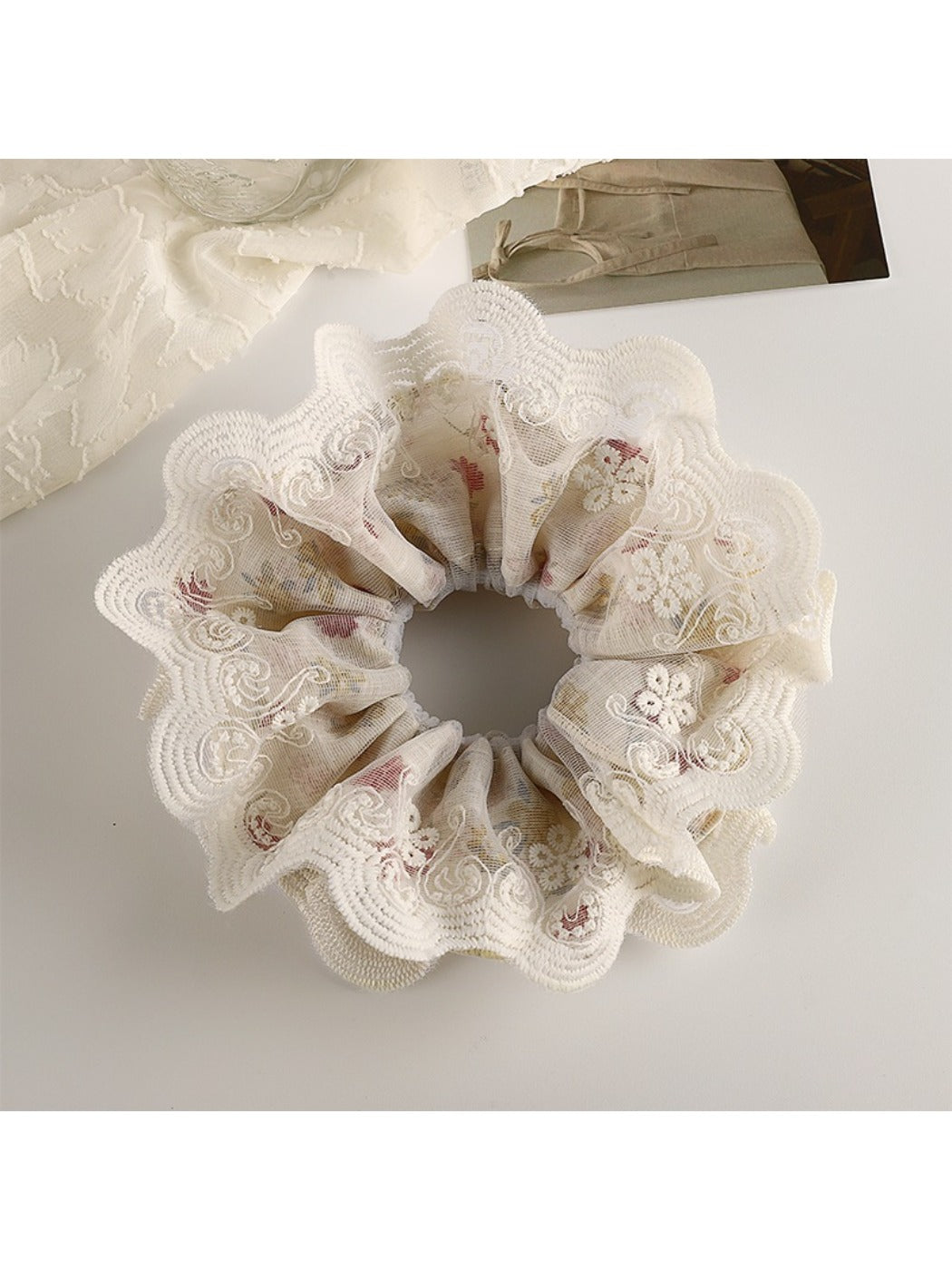 Gifty vintage double layer scrunchie with floral print held in hand against neutral background