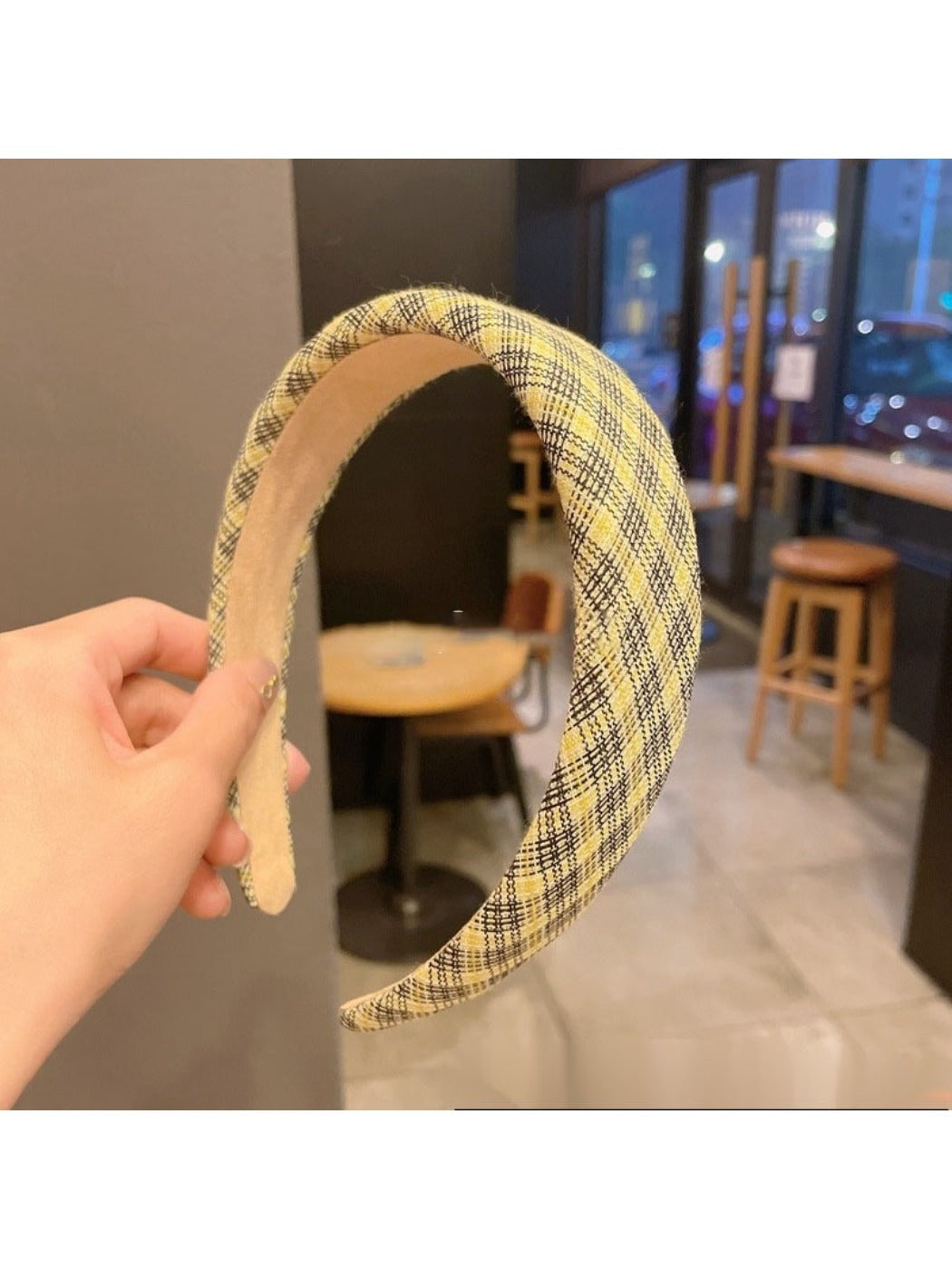 Yellow style headband with bow displayed on a light gray surface