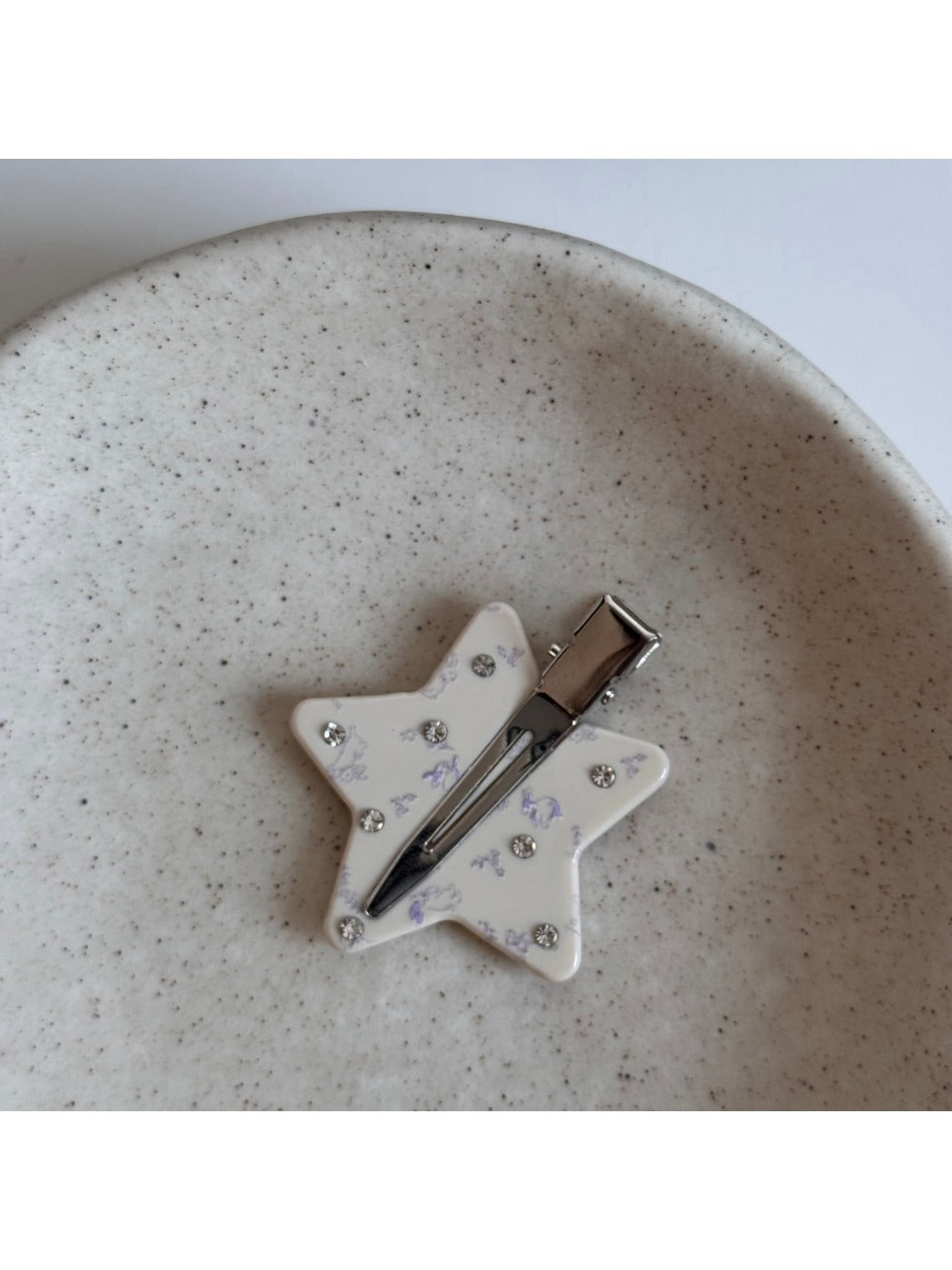 Beau printed triangle star hair clip shown from above emphasizing star pattern and shape