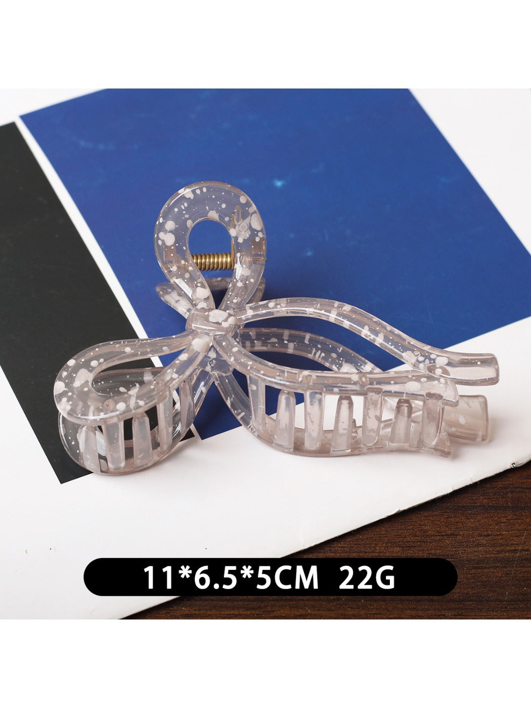 Beau sheer bow shape claw clip shown with packaging box on a neutral background