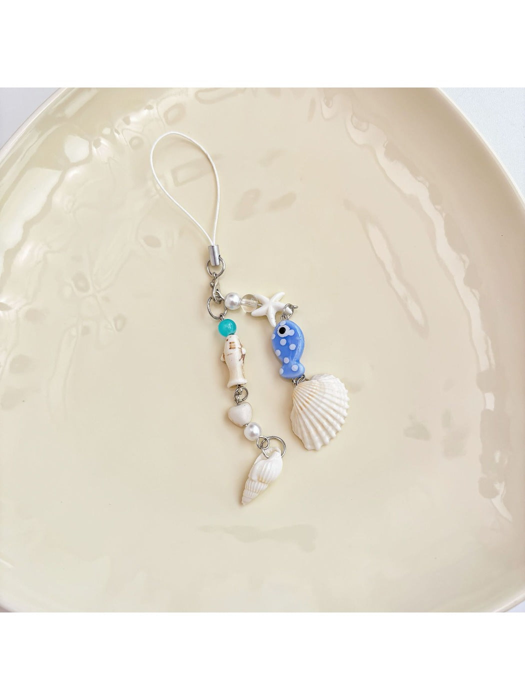 Blue fish keychain attached to a silver keyring on a white background