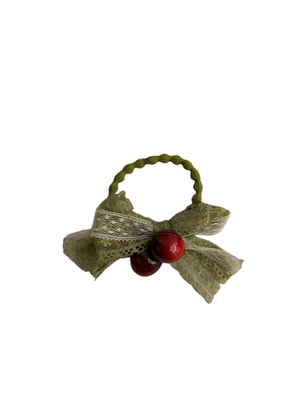 Close-up of green lace bow hair tie showing delicate lace texture
