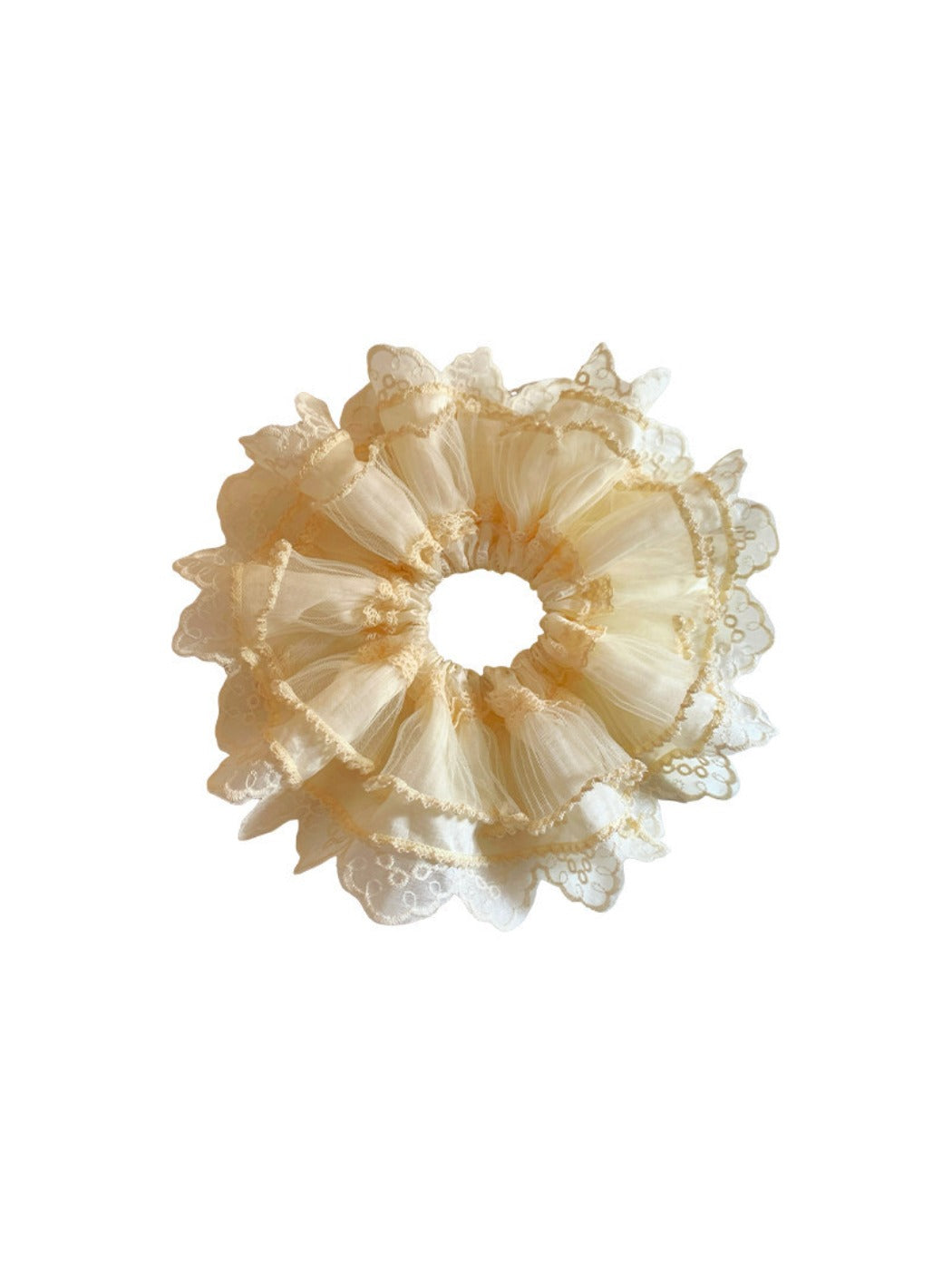 Beige lace-trimmed tulle scrunchie styled on a wooden surface