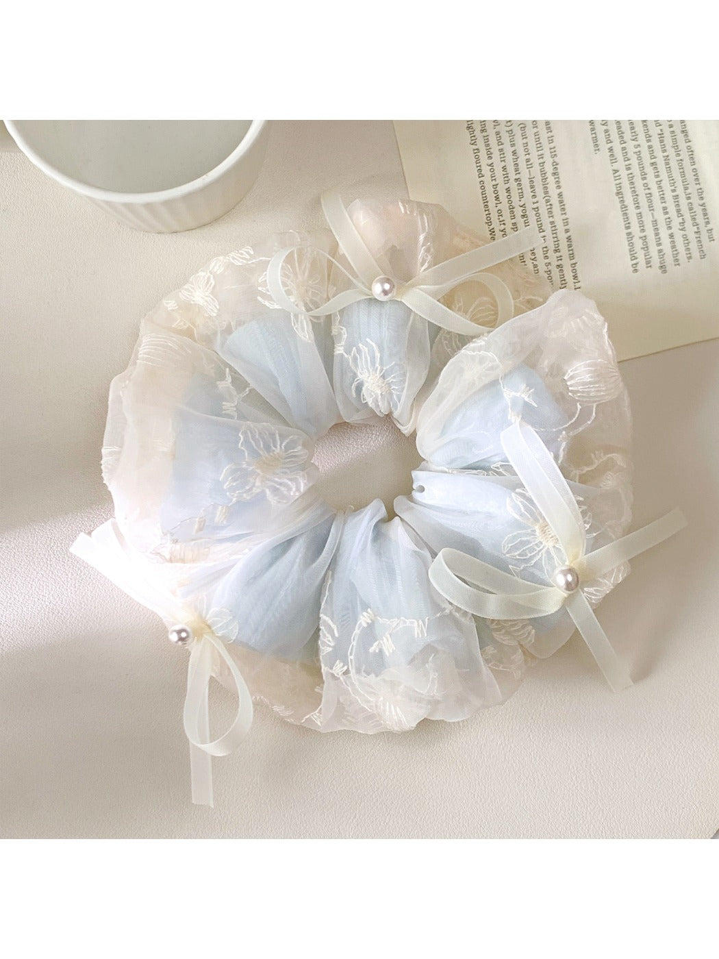 Gifty scrunchie styled in hair, emphasizing the bow and soft fabric appearance
