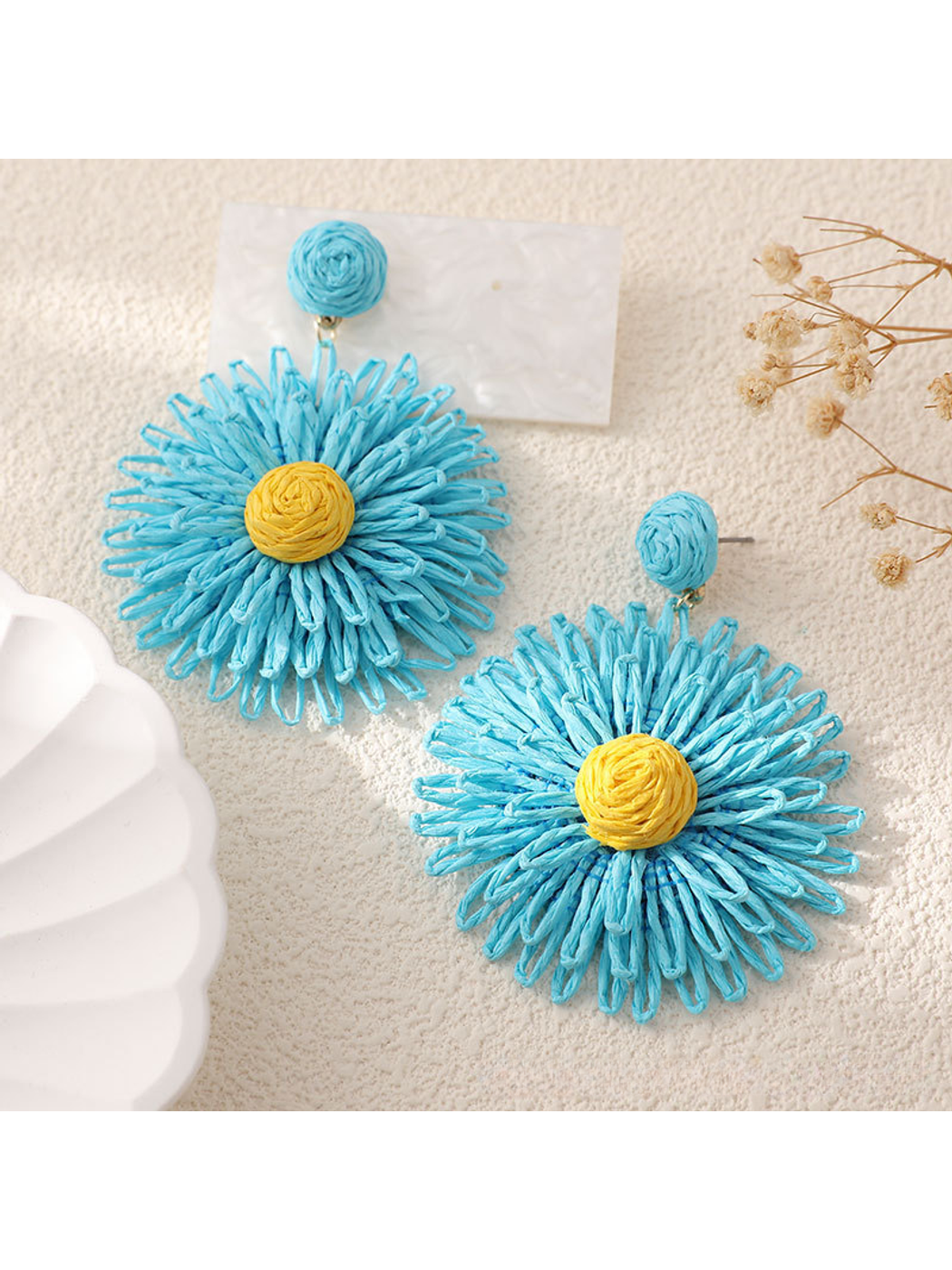 Artistic shot of colorful floral raffia drop earrings with soft lighting