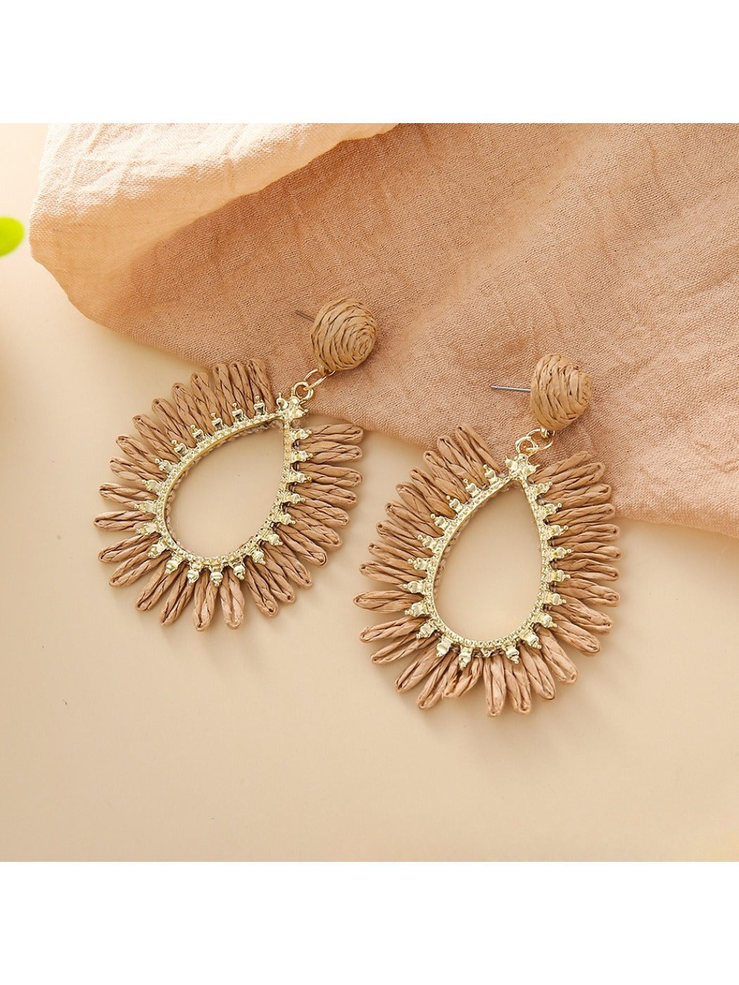 Earedge raffia teardrop hollow earrings displayed on beige fabric background