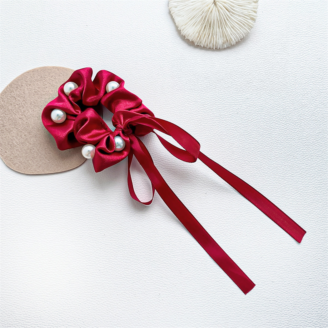 Red beaded bow scrunchie with trailing ribbons