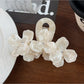 Beau floral hair claw clip shown open to display inner clasp mechanism and design
