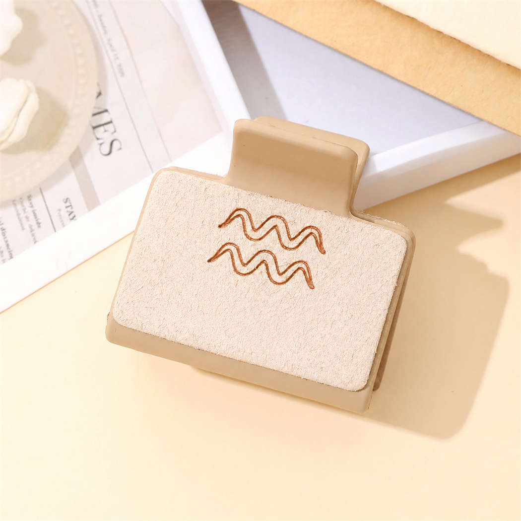 Western zodiac symbol hair claw - Aquarius angled view