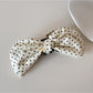 Beau elegant bow banana clip displayed on a flat surface, bow facing up