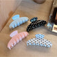 Side view of Beau Sweet Polka Dot Stripe Claw Clip displaying clip teeth and pattern
