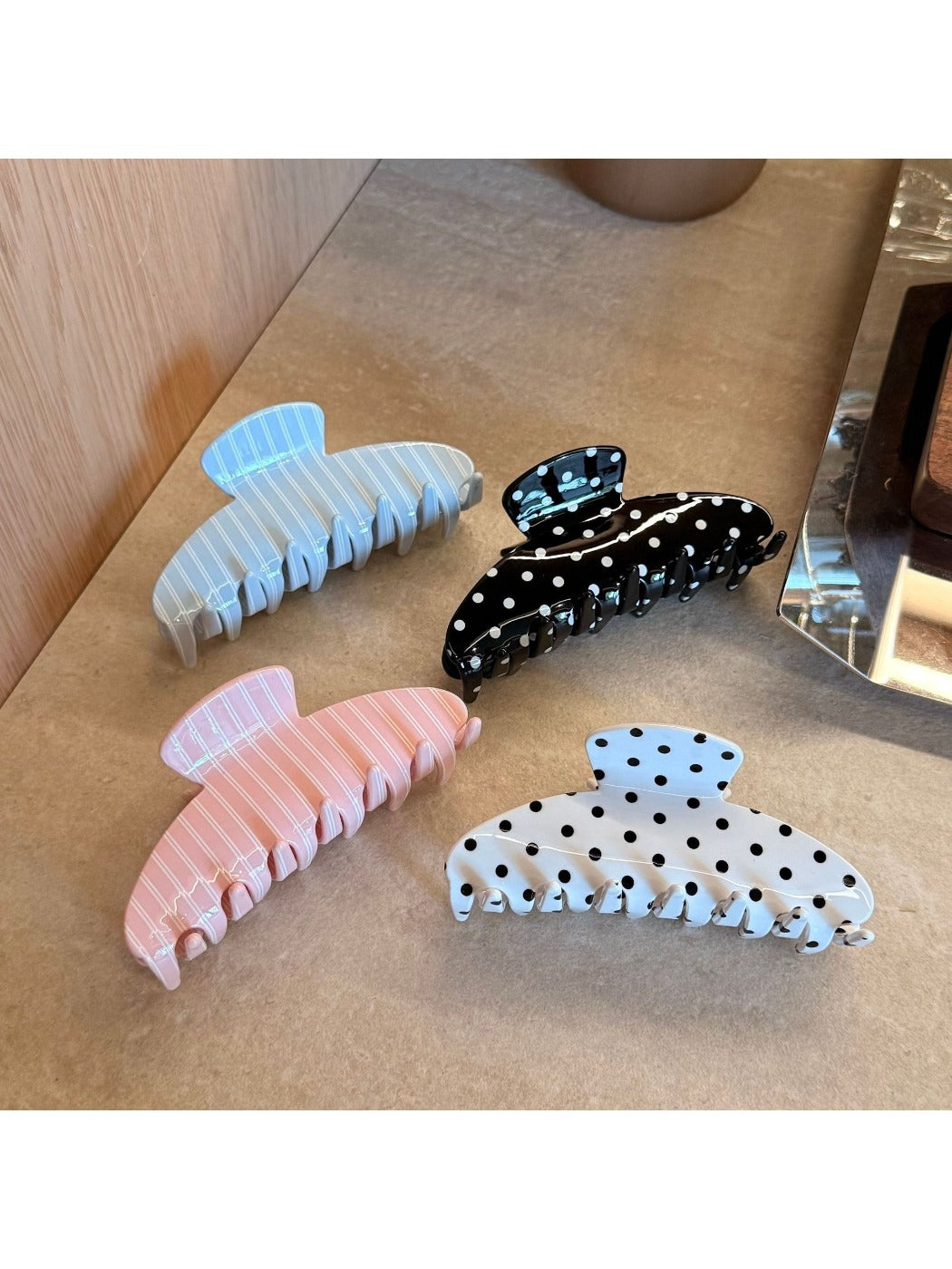 Side view of Beau Sweet Polka Dot Stripe Claw Clip displaying clip teeth and pattern
