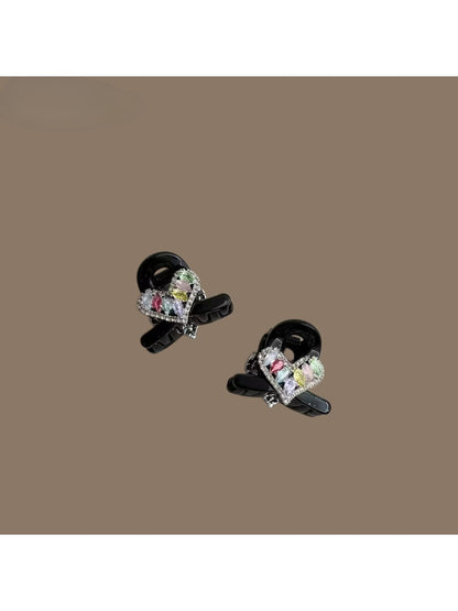 Beau mini hair claw clip in light beige holding a small section of hair