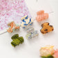 Side view of Beau fresh acetate hair clip highlighting curved design
