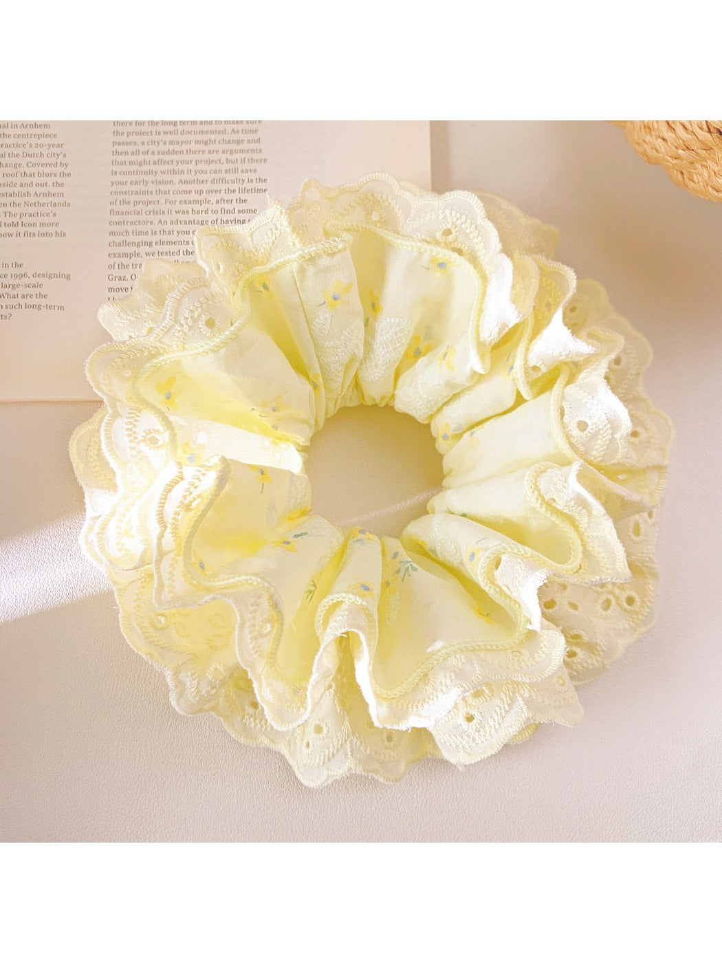 Gifty yellow ruffle scrunchie displayed flat showing gathered fabric details