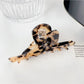 Beau hair claw clip with multicolor floral design on neutral background