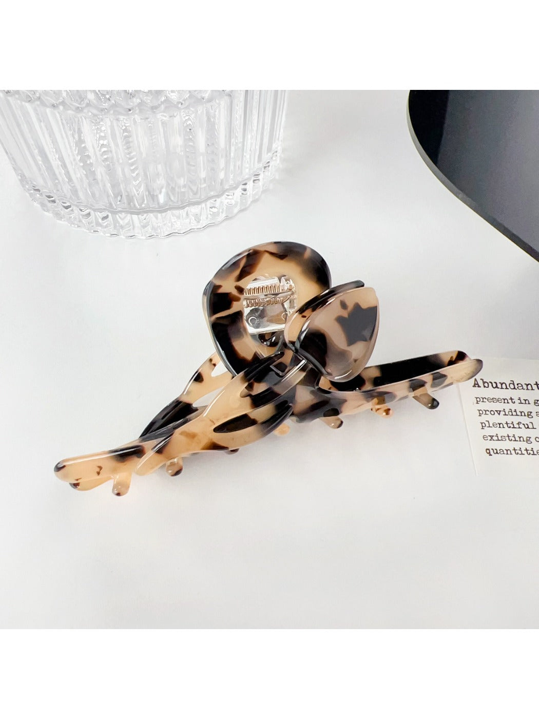 Beau hair claw clip with multicolor floral design on neutral background