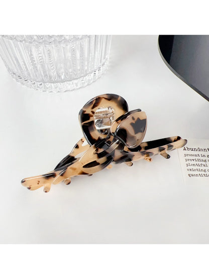 Beau hair claw clip with multicolor floral design on neutral background