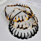 Gifty acetate headband with wavy toothed design in translucent amber color