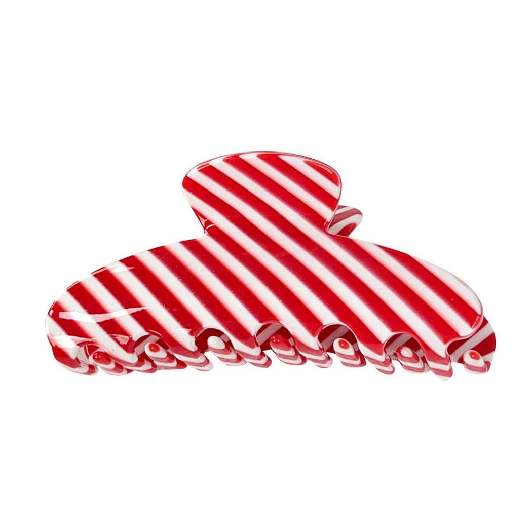 Red and white striped hair claw clip on white background
