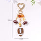 Keychain pendant shaped like a basketball with orange and black colors
