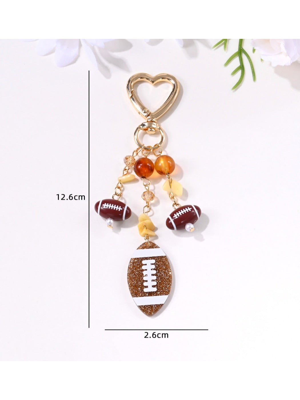 Keychain pendant shaped like a basketball with orange and black colors