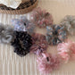 Side view of floral scrunchie showing gathered fabric texture