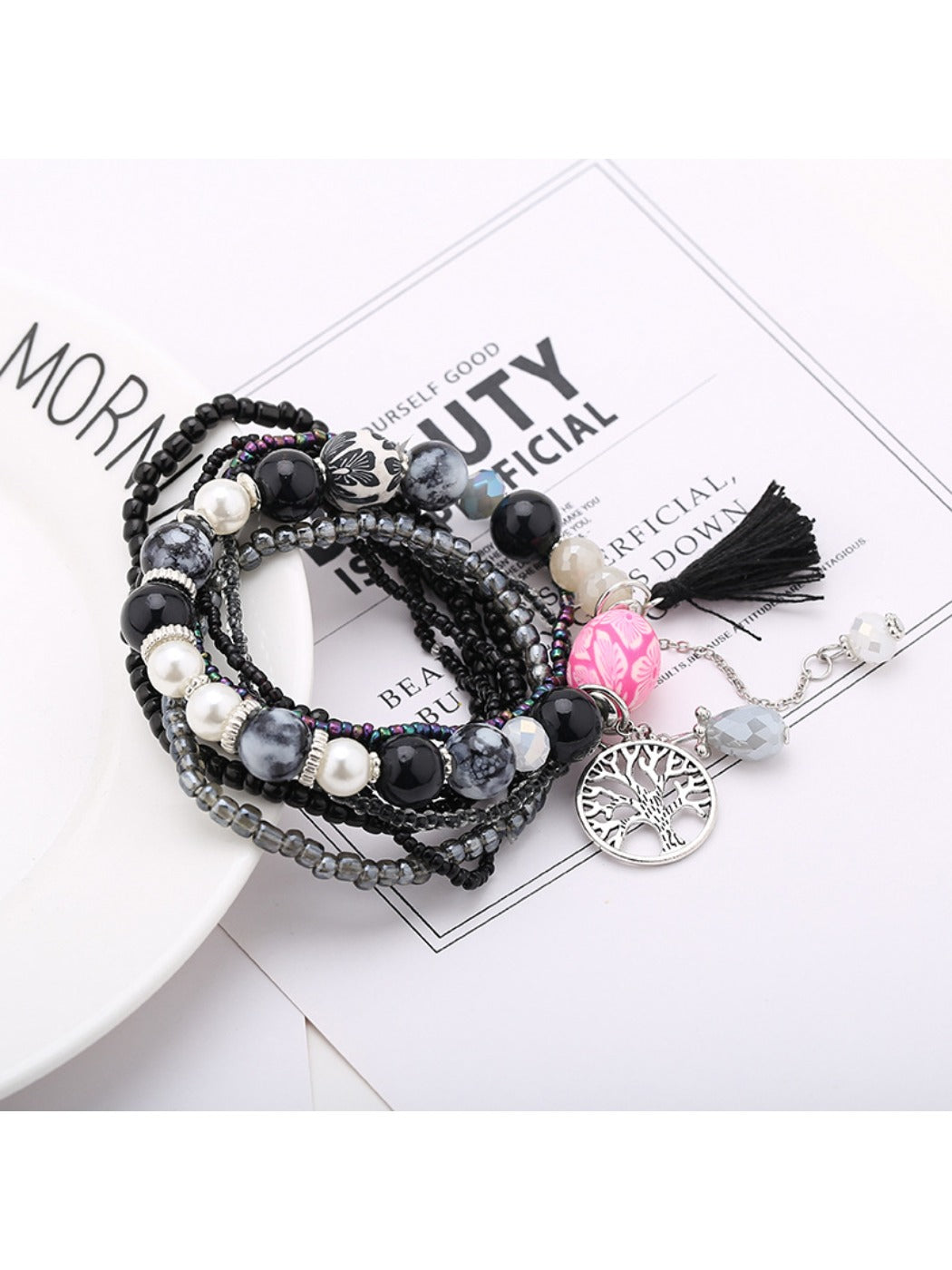 Detailed shot of tassel pendant and beads on Lovra tree shape tassel pendant bracelet