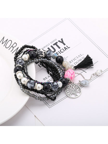 Detailed shot of tassel pendant and beads on Lovra tree shape tassel pendant bracelet