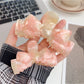 Beau hair claw clip holding a section of blonde hair
