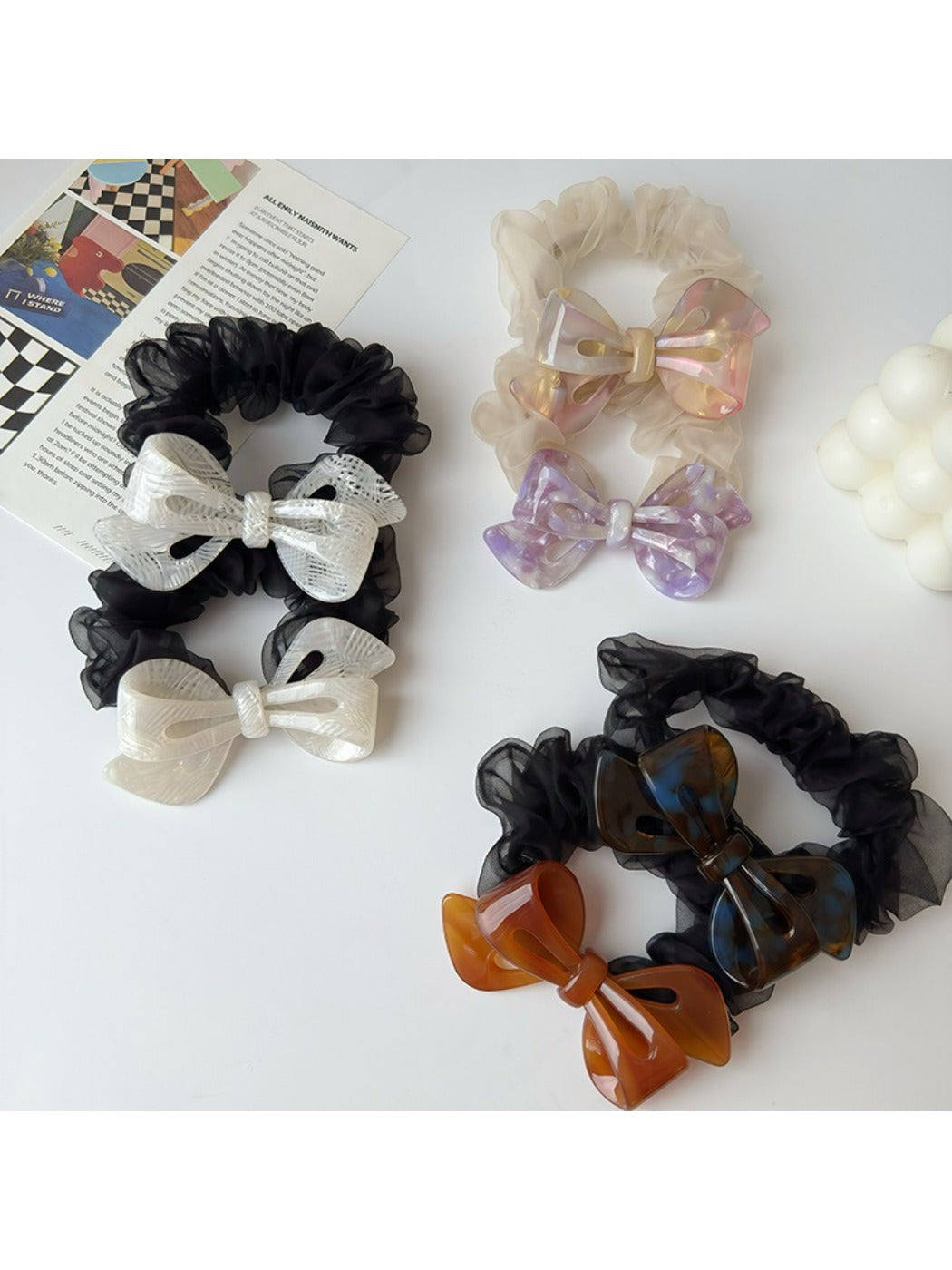 Close-up of Gifty mesh bow acetate scrunchie in soft pastel color