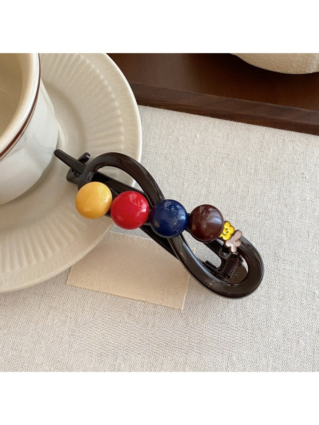 Beau hair clip worn in brown hair, displaying vibrant round beads